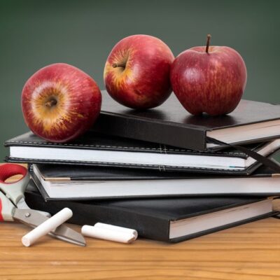 three Tutorial Bundle - stack of textbooks with apples, chalk and scissors